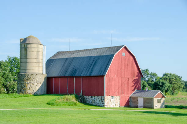 Old concrete stave silo on stone base near Beaver Dam\nWisconsin, USA.