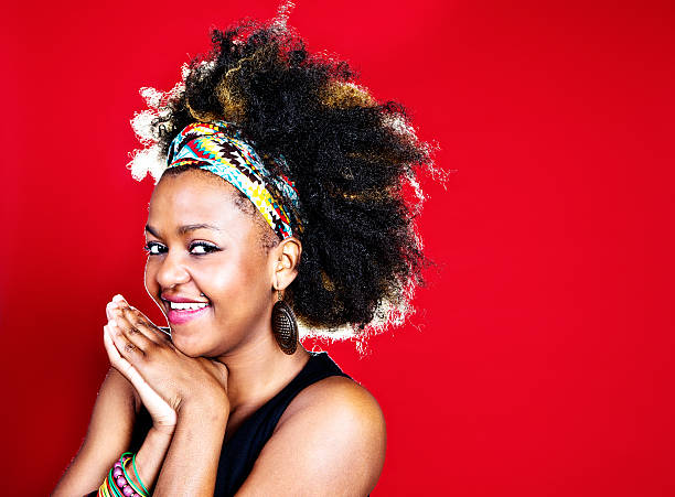 istock Cute young Afro-haired woman smiling with clasped hands 174957237