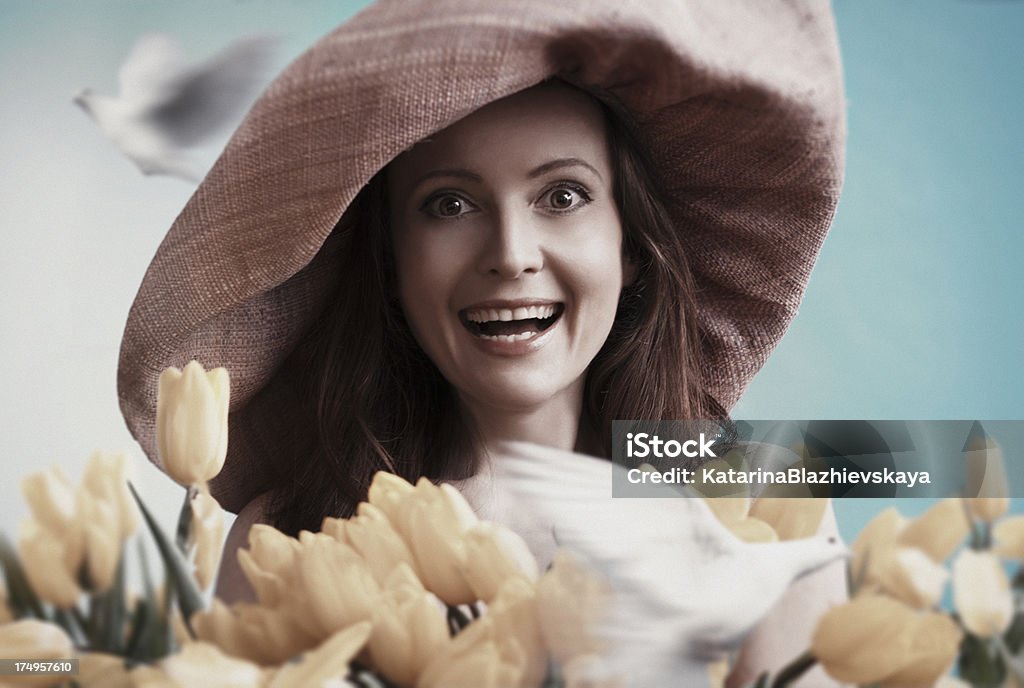 Spring happy portrait Portrait of laughing happy woman with tulips and flying doves. Digitally generated image. Tonalities and little grain are added. Bouquet Stock Photo