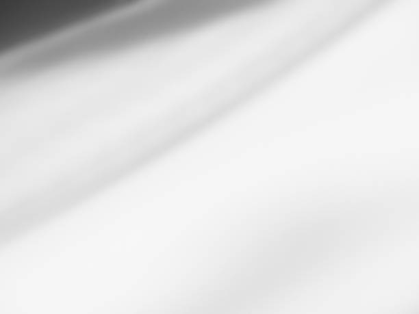 istock White Cloth Fabric Silk Texture Sheet Wave Luxury Drape Ripple Satin Soft Material Silky Abstract Mesh Pattern Fashion Fold Pure Wrinkle Canvas Template Shadow Drape Gradient Textile Banner Material. 1749580312
