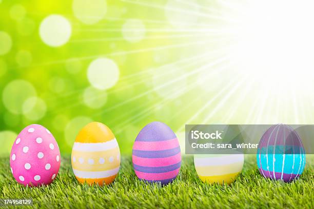 Decoradas Huevos De Pascuas En El Césped Con Fondo Verde Foto de stock y más banco de imágenes de Alimento