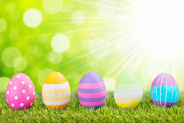 istock Decorated Easter eggs in the grass with a green background 174958129