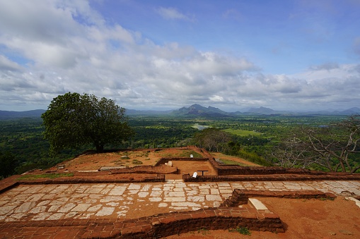 Sigiriya, Dambulla, Sri Lanka - May 13, 2022: Elevated atop Sigiriya, the eyes are treated to a cascading vista of emerald mountains, reaching out to meet the expansive blue heavens, painting a scene of nature's grandeur.