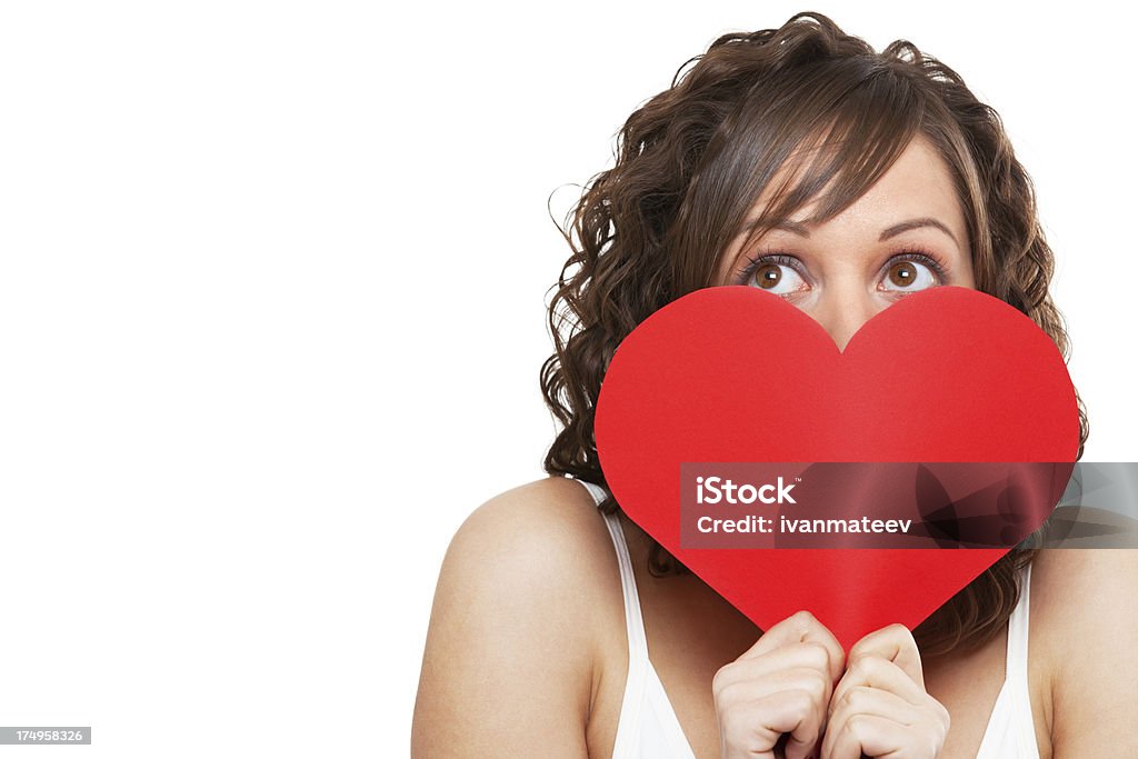 Young woman holding red paper heart Young attractive woman holding red paper heart like a valentine card and hiding her face Adult Stock Photo