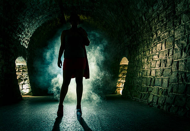 Black & white shot with a silhouette of a girl running in a tunnel