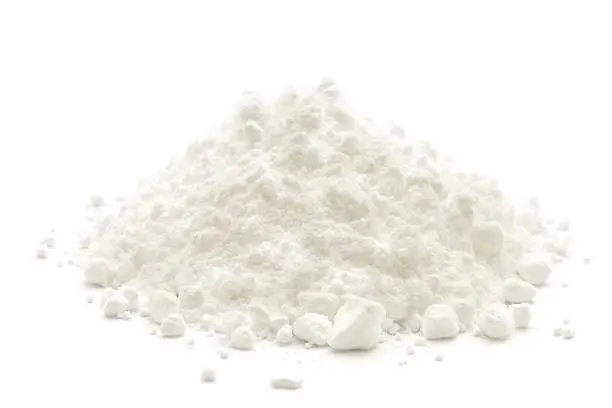 Photo of A small heap of icing sugar on a white background