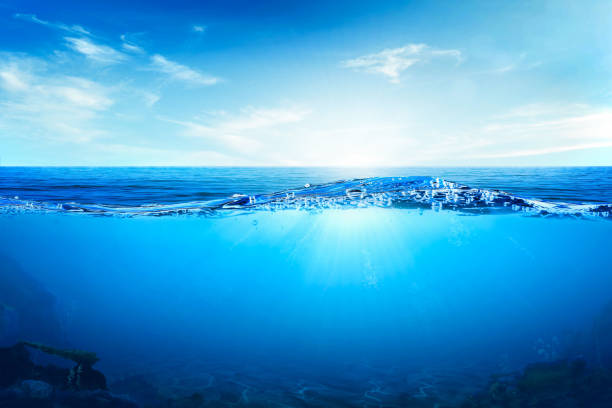 istock BLUE UNDER WATER waves and bubbles. Beautiful white clouds on blue sky over calm sea with sunlight reflection, Tranquil sea harmony of calm water surface. 1749588502