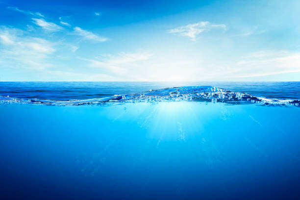 istock BLUE UNDER WATER waves and bubbles. Beautiful white clouds on blue sky over calm sea with sunlight reflection, Tranquil sea harmony of calm water surface. 1749588506