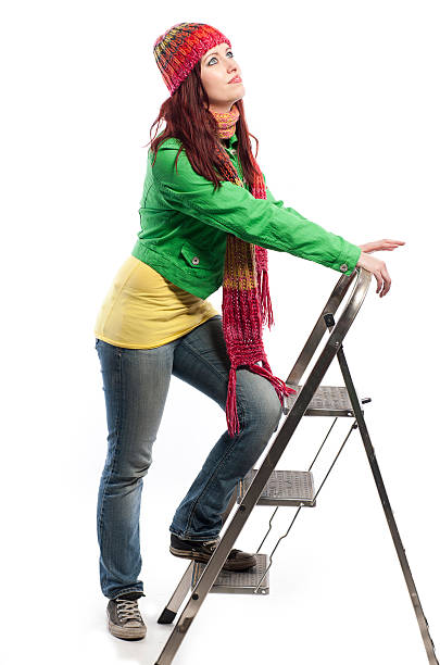 The racer overcomes the obstacle by climbing the ladder, focused on the sole of the shoe