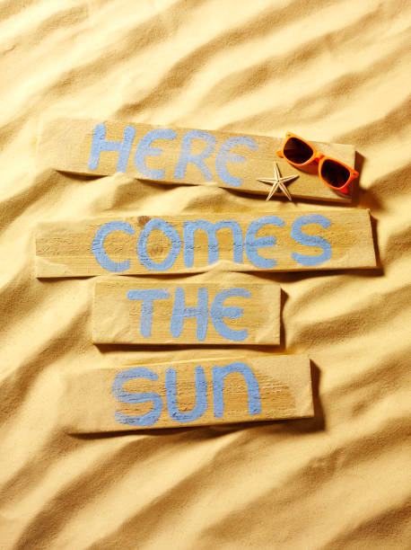 istock Sunglasses with Here Comes the Sun Sign 174959112