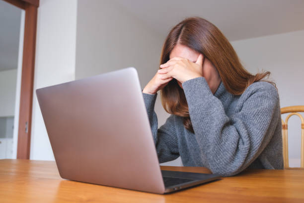istock A woman get headache and stressed while working online on laptop computer at home 1749592454