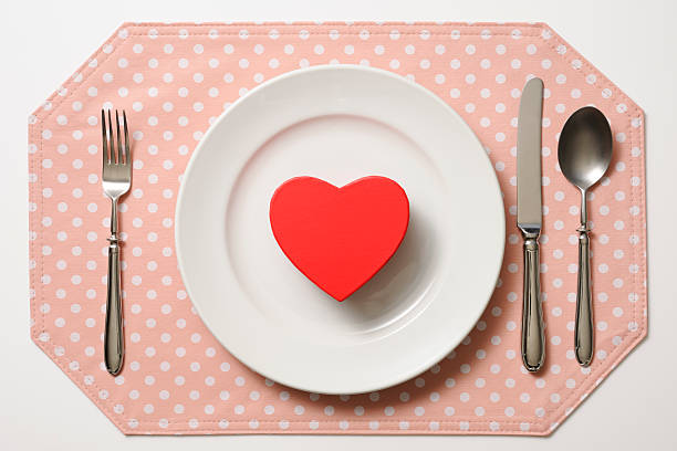 istock Red heart shape with white plate on pink place mat 174959600
