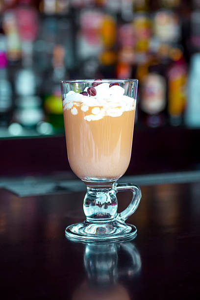 Classic Irish Coffee hot cocktail on the black bar table stock photo