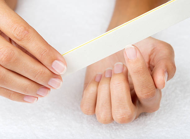 Manicure - Filing Nails stock photo