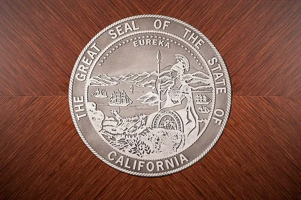 The great seal of the state of California hanging in a courtroom