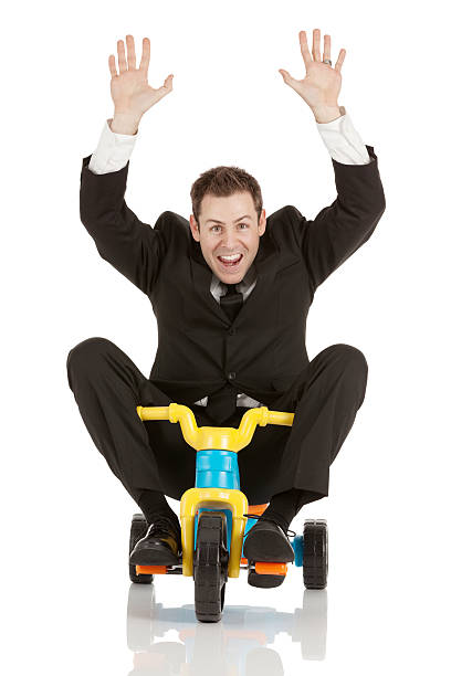 podekscytowany biznesmen jechać na trycykl - tricycle full length men bizarre zdjęcia i obrazy z banku zdjęć