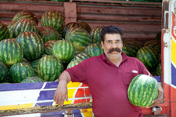 Sarvoda, Sughd Province, Tajikistan. August 16, 2021. Vendor selling watermelons out of their car at the market in Sarvoda.