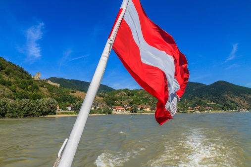 Austrian flag waving during a cruise on the Danube river.