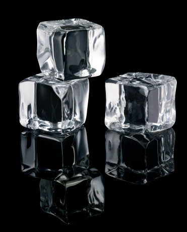 Three Ice Cubes with reflections isolated on Black Background. More like this on my portfolio