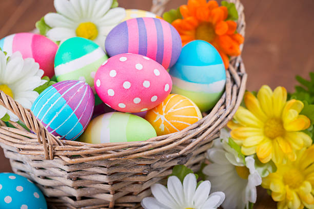 Basket with colourful hand-painted Easter eggs stock photo