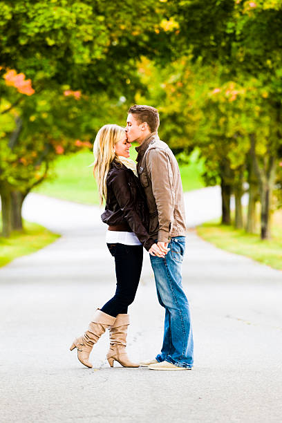 Men kissing his Forehead's girlfriend