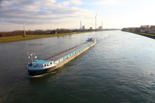 Modern barge on river Rhine near Karlsruhe; in the background: new power station; late afternoon light.Please see related pictures :