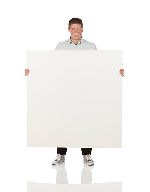 istock Attractive young smiling man with a placard 174961724