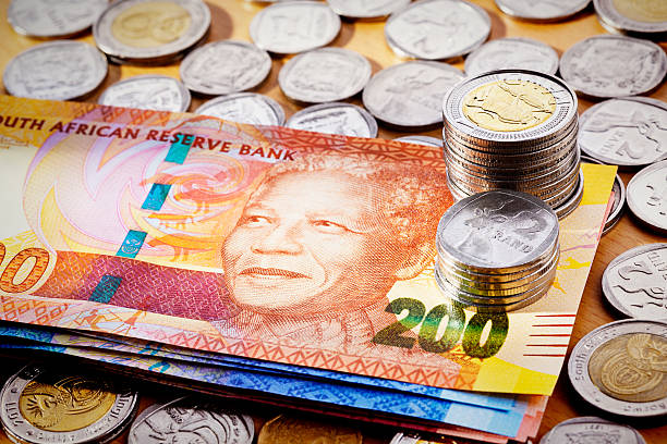 istock Stack of new South African Mandela banknotes with silver coins 174962484