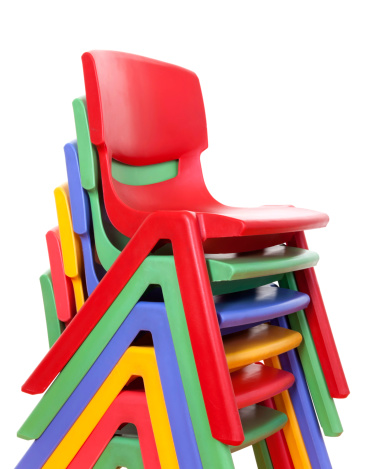 five stacked plastic chairs.