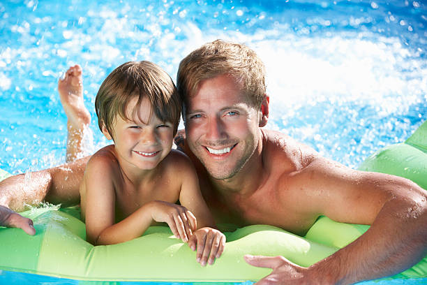 istock Father And Son On Holiday In Swimming Pool 174963077