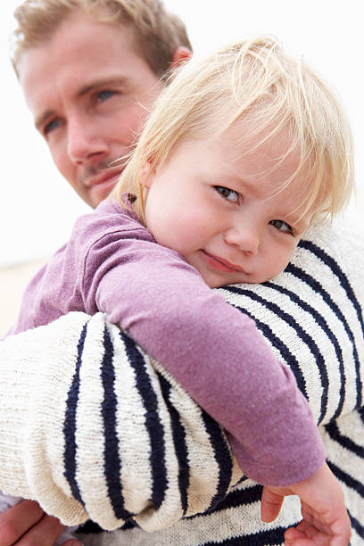 istock Father Cuddling Young Daughter Outdoors 174963080