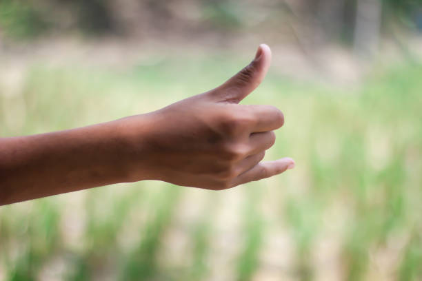 istock A man shows his two finger thumbs up and a blurred background 1749632520