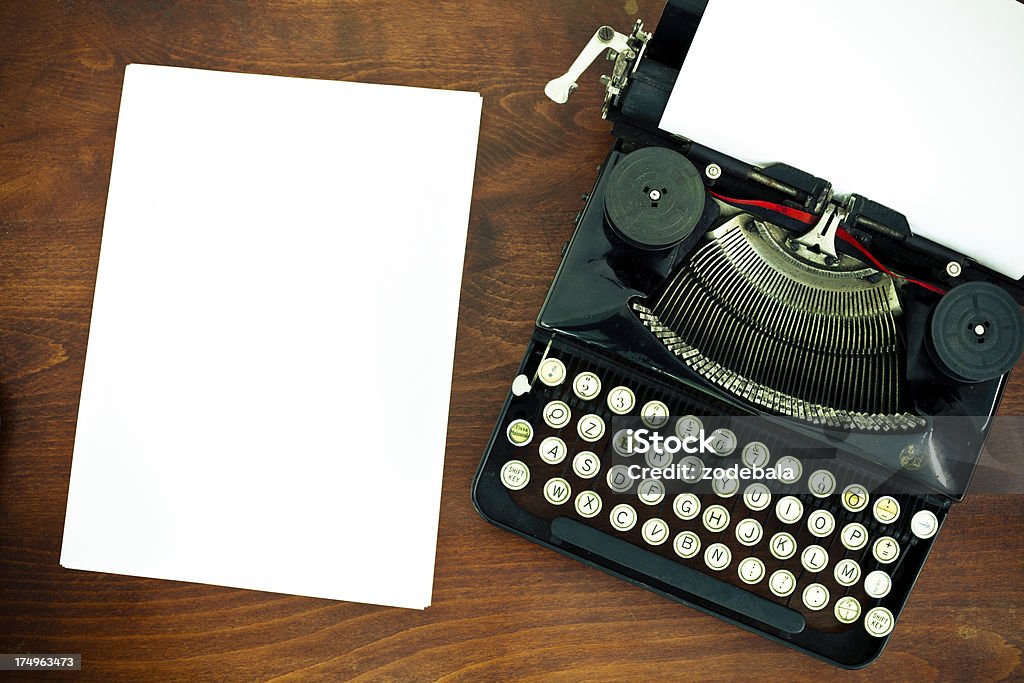 Old Vintage Typewriter and White Paper Vintage typewriter on wood table Alphabet Stock Photo