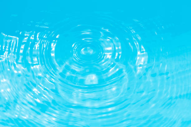 istock Defocus blurred transparent blue colored clear calm water surface texture with splashes reflection. Trendy abstract nature background. Water waves in sunlight with copy space. Blue watercolor shine. 1749636345