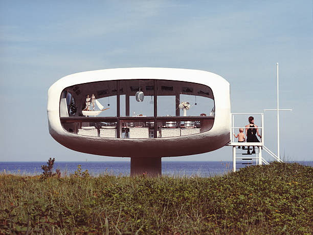 A family on holiday at the beach Mother with little son enjoying the view over the sea next to a cabin on the beach. beach hut photos stock pictures, royalty-free photos & images