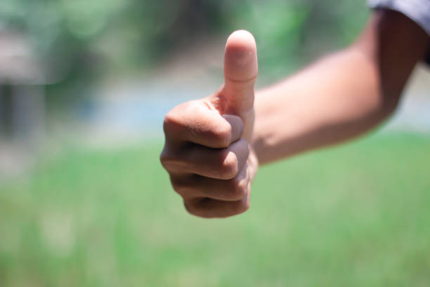 istock A man shows his finger thumbs up and a blurred background 1749636857