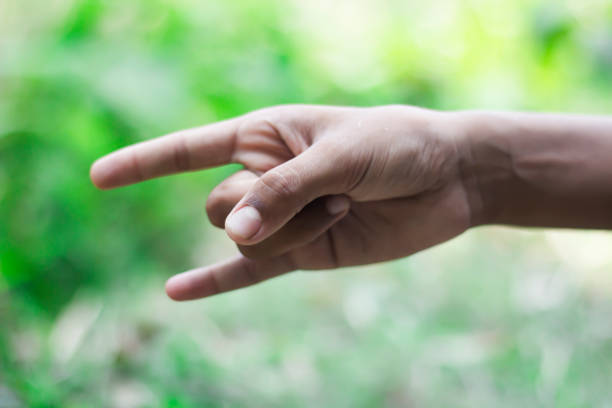 istock A man raises his two fingers upside and the background is blurred 1749637373