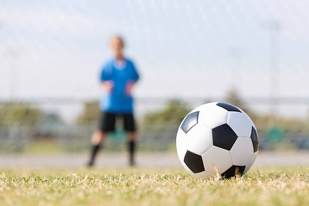 istock Soccer ball on field during kids game; selective focus 174963751