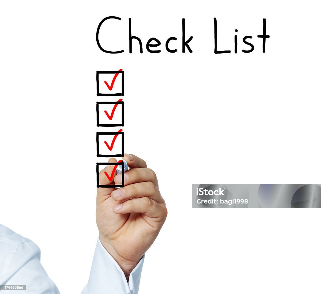 Checking the checklist Human hand drawing a check mark at the whiteboard Check Mark Stock Photo