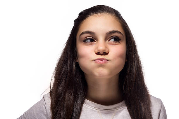 istock Teenager blowing out cheeks 174963921