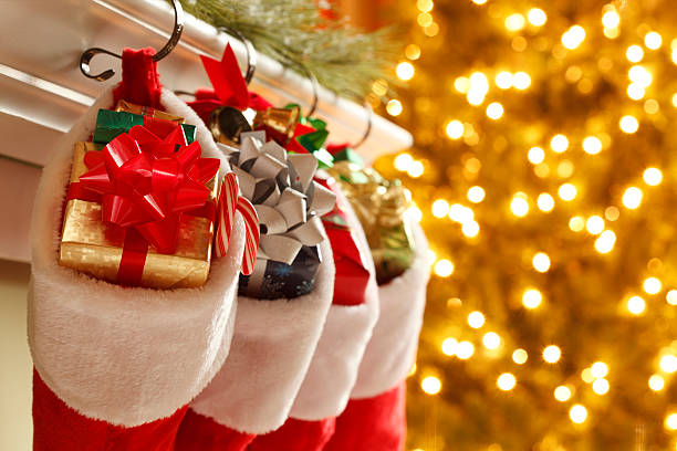 Christmas Stockings Christmas stockings in front of a blurred Christmas tree.To see more holiday images click on the link below: stuffed christmas stockings stock pictures, royalty-free photos & images