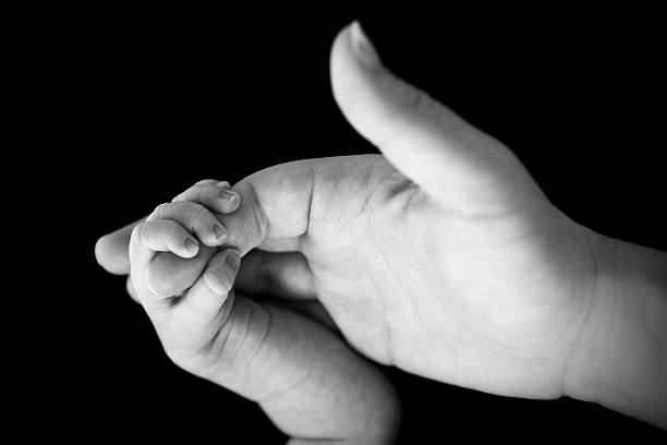 istock Newborn Holding Mom's Finger 174965248