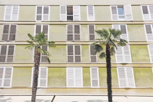 weathered hotel facade with palm trees in Zadar Croatia