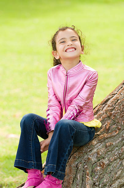 Girl Smiling on a Tree stock photo