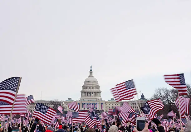 Presidential Inauguration 2013 .  Flag waving spectators throng the Washington Mall near the capital.