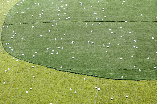 Closer look at empty Golf driving range - behind the protection netting