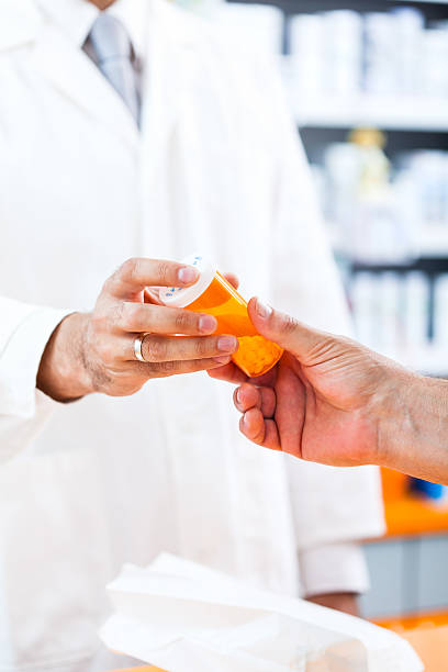 istock Pharmacist giving pills to customer 174966714