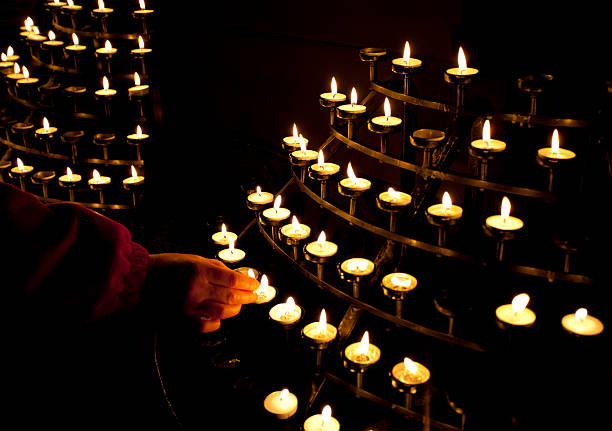 istock Lighting candles in a church 174966799
