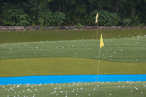 Closer look at empty Golf driving range - behind the protection netting