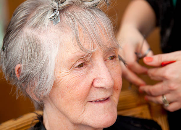 istock senior woman having haircut 174967600